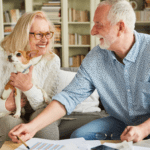 April 25 Events Page Image - The Ranch Estates at Scottsdale Elderly man and woman smiling and holding small dog