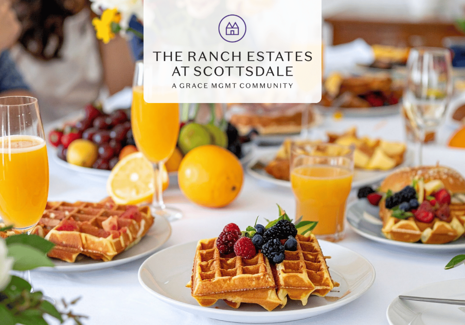 Brunch table with waffles topped with berries, glasses of orange juice, and a fruit platter; logo overlay reads The Ranch Estates at Scottsdale.